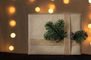 Handmade christmas paper gift. Christmas craft gift box with tree. Christmas eve preparation packaging. Packing present box. Natural eco rustic style decor photo