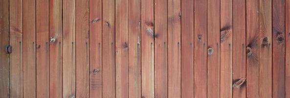 Close up of brown wooden fence panels. Many vertical wooden planks photo