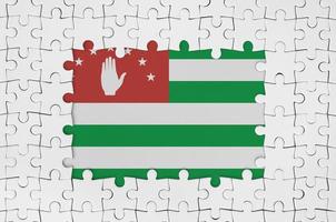 Abkhazia flag in frame of white puzzle pieces with missing central part photo