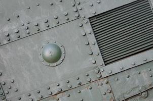 Abstract green industrial metal textured background with rivets and bolts photo