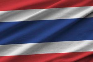 Thailand flag with big folds waving close up under the studio light indoors. The official symbols and colors in banner photo