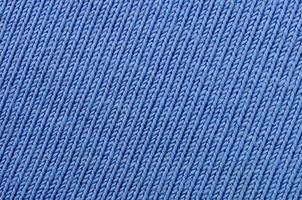 The texture of the fabric in blue color. Material for making shirts and blouses photo