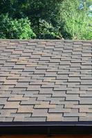 Modern roofing and decoration of chimneys. Flexible bitumen or slate shingles photo