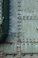 Abstract green industrial metal textured background with rivets and bolts photo