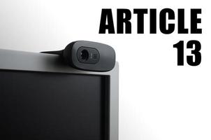 A modern web camera on monitor and article 13 inscription photo