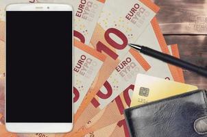10 euro bills and smartphone with purse and credit card. E-payments or e-commerce concept. Online shopping and business with portable devices photo