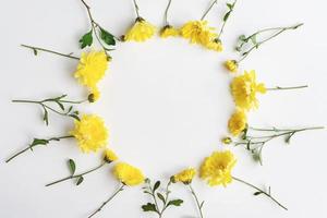 Yellow flowers round frame on white background, chrysanthemum floral wreath, copy space photo