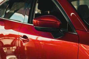 Red car in dealership showroom, new cars sale, automotive background photo