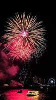 fireworks celebration on the river in the dark sky photo