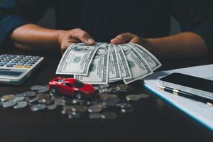 Concept of car insurance business, saving buy - sale with tax and loan for new car. Car toy vehicle with stack coin money on background. Planning to manage transportation finance costs. loan for car photo