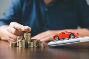 Concept of car insurance business, saving buy - sale with tax and loan for new car. Car toy vehicle with stack coin money on background. Planning to manage transportation finance costs. loan for car photo