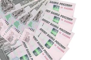 1000 russian rubles bills lies isolated on white background with copy space stacked in fan shape close up photo