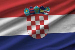 Croatia flag with big folds waving close up under the studio light indoors. The official symbols and colors in banner photo