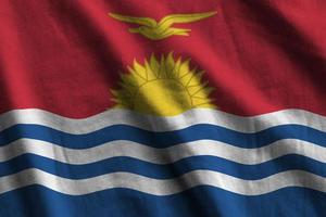 Kiribati flag with big folds waving close up under the studio light indoors. The official symbols and colors in banner photo