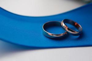 old wedding rings on blue ribbon photo