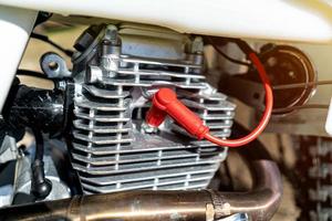 Enduro cylinder and motorcycle spark plug close up. photo