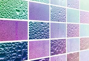 A collage of many different fragments of glass, decorated with rain drops from the condensate. Purple and violet tones photo