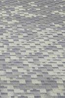 Background mosaic texture of flat roof tiles with bituminous coating photo