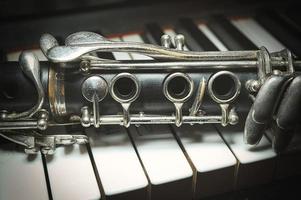 An antique clarinet leaning piano photo