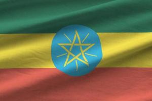 Ethiopia flag with big folds waving close up under the studio light indoors. The official symbols and colors in banner photo