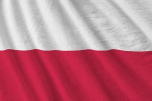 Poland flag with big folds waving close up under the studio light indoors. The official symbols and colors in banner photo