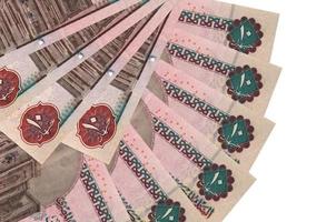 10 Egyptian pounds bills lies isolated on white background with copy space stacked in fan shape close up photo