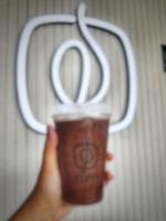 Jakarta, Indonesia in October 2022. Blurred photo of A hand is holding an iced moccachino belonging to the Fore brand.