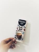 Jakarta, Indonesia in October 2022. A hand holding a typical Turkish Nescafe coffee. photo