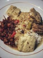 Photo of a plate of homemade food, rice with side dishes of smoked fish, tofu and tempeh