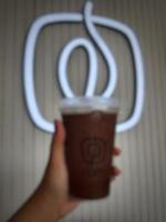 Jakarta, Indonesia in October 2022. A hand is holding an iced moccachino belonging to the Fore brand. photo