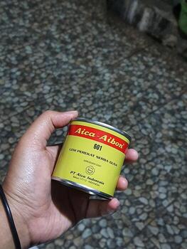 Central Java, Indonesia in October 2022. A hand holding Aica Aibon glue. photo