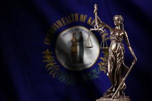 Kentucky US state flag with statue of lady justice and judicial scales in dark room. Concept of judgement and punishment photo