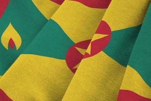 Grenada flag with big folds waving close up under the studio light indoors. The official symbols and colors in banner photo