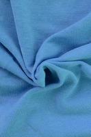 The texture of the fabric in blue color. Material for making shirts and blouses photo