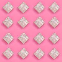 A lot of pink gift boxes lies on texture background of fashion pastel pink color paper in minimal concept. Abstract trendy pattern photo