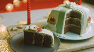 Kerstmis taart met peperkoek koekjes in de vorm van de kerstman claus. vakantie atmosfeer met kaarsen en lichten video