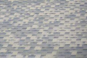 Background mosaic texture of flat roof tiles with bituminous coating photo