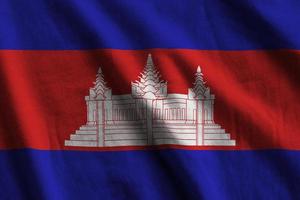 Cambodia flag with big folds waving close up under the studio light indoors. The official symbols and colors in banner photo