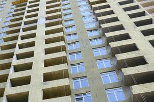 Residential multi store apartement building house facade under construction photo