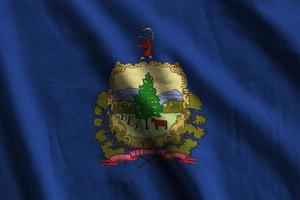 Vermont US state flag with big folds waving close up under the studio light indoors. The official symbols and colors in banner photo