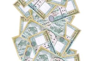 100 Nepalese rupees bills flying down isolated on white. Many banknotes falling with white copyspace on left and right side photo