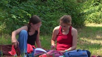 Mother and Daughter Studying in Nature on Grass video