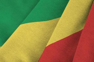 Congo flag with big folds waving close up under the studio light indoors. The official symbols and colors in banner photo