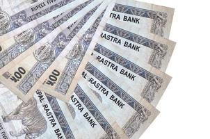 500 Nepalese rupees bills lies isolated on white background with copy space stacked in fan shape close up photo