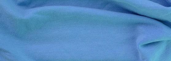 The texture of the fabric in blue color. Material for making shirts and blouses photo