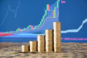 Golden coin stacks arranged as a graph. Increasing columns of coins photo