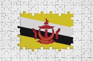 Brunei Darussalam flag in frame of white puzzle pieces with missing central part photo
