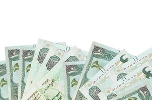 10 UAE dirhams bills lies on bottom side of screen isolated on white background with copy space. Background banner template photo