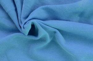 The texture of the fabric in blue color. Material for making shirts and blouses photo