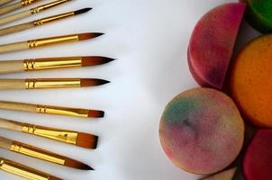 Color cosmetics, brushes and sponges for face painting on white background